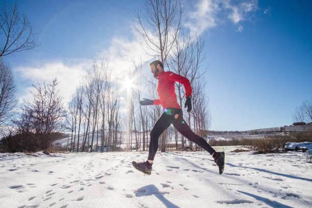 istock Man running on the snow in a winter day 875673574