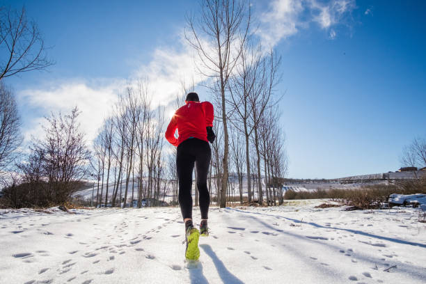 istock Man running on the snow in a winter day 875673668