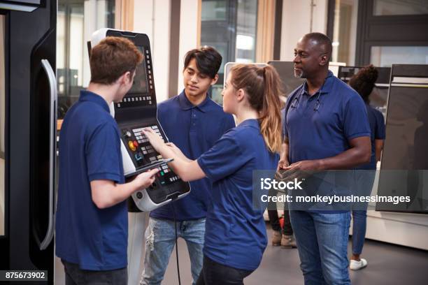 Engineer Showing Apprentices How To Use Cnc Tool Making Machine Stock Photo - Download Image Now