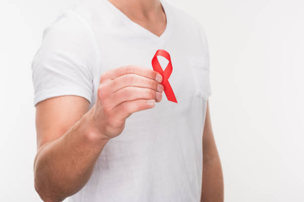 istock man holding aids ribbon 875676978