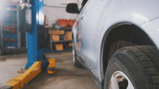istock Car service - white vehicle in workshop for repairing or checking 875681622