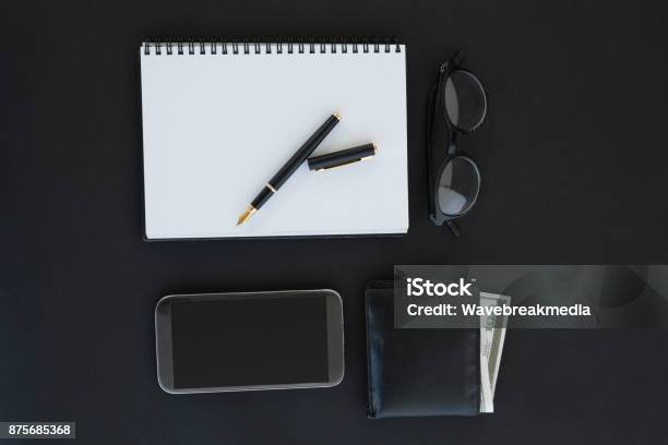 Spectacles Organizer Pen Mobile Phone And Wallet On Background Stock Photo - Download Image Now