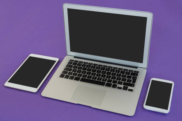 istock Laptop, mobile phone and digital tablet on purple background 875685554