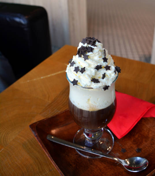 istock Cup of foamy cappuccino on a plate on a wooden table. 875689294