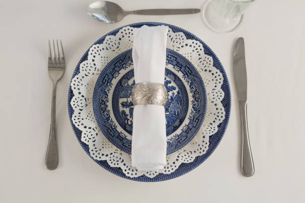 istock Fork, butter knife, spoon, napkin and lace placemat 875689748