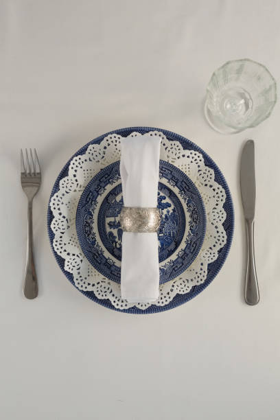 istock Fork, butter knife, spoon, napkin and lace placemat 875689782