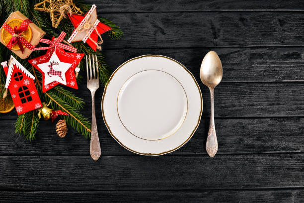 istock Christmas table decoration. Christmas dinner plate, cutlery decorated festive decorations. Winter holidays. Christmas card. Free space for your text. Merry Christmas, Happy New Year. 875692794