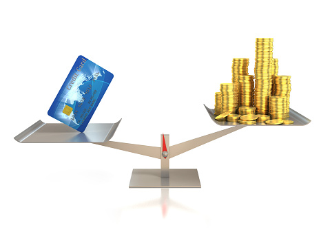 3d illustration of credit card and golden coins on balance scale
