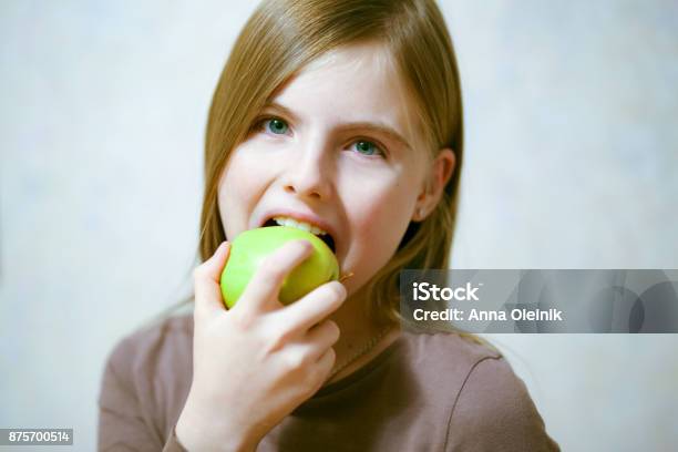 Beautiful Young Girl Eating Green Apple Stock Photo - Download Image Now - Adult, Adults Only, Apple - Fruit