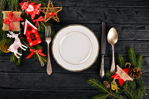 istock Christmas table decoration. Christmas dinner plate, cutlery decorated festive decorations. Winter holidays. Christmas card. Free space for your text. Merry Christmas, Happy New Year. 875701094