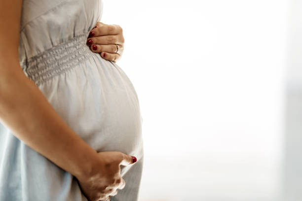 istock Pregnant woman holding her belly 875708146