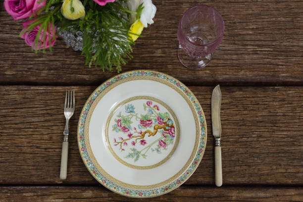 istock Fork and butter knife with plate arranged on wooden table 875711088