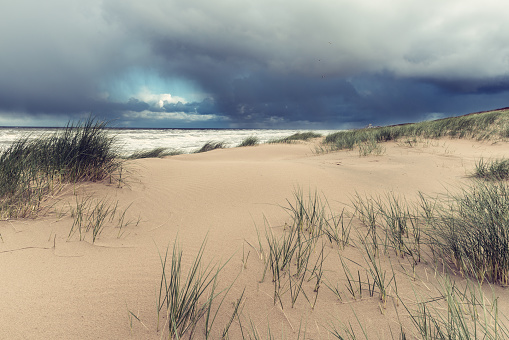 Storm over an ocean and sand dune - nature seascape background