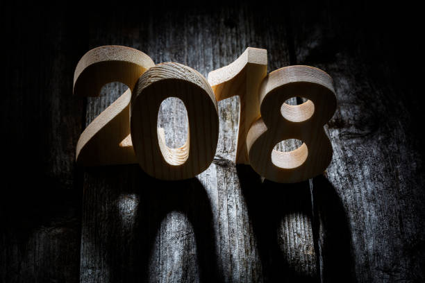 istock Happy New Year 2018 back lit wooden letters 875715258