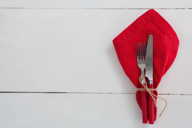 istock Fork and butter knife with napkin tied up with a rope 875720770