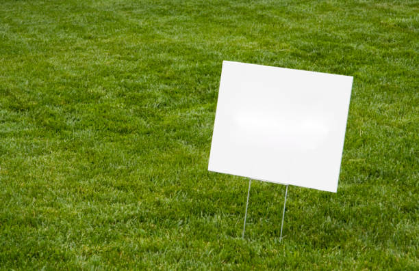 Blank Sign on Lawn Blank white sign on newly cut grass. Copy space. Horizontal. yard sign stock pictures, royalty-free photos & images