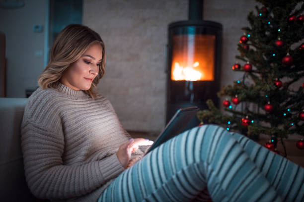 istock Woman using digital tablet on Christmas eve 875722870