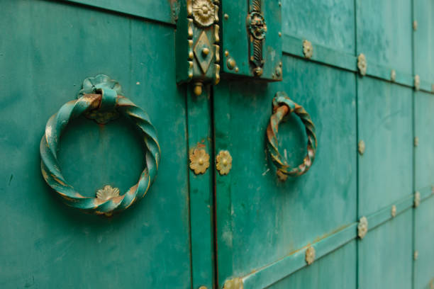 Old green vintage gates with round handles
