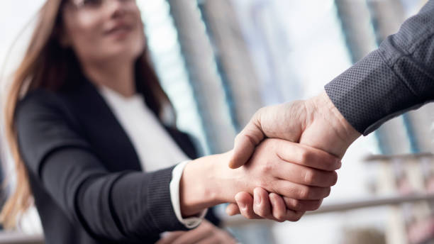 businesspeople handshake close up view - lawyer young adult suit expressing positivity imagens e fotografias de stock