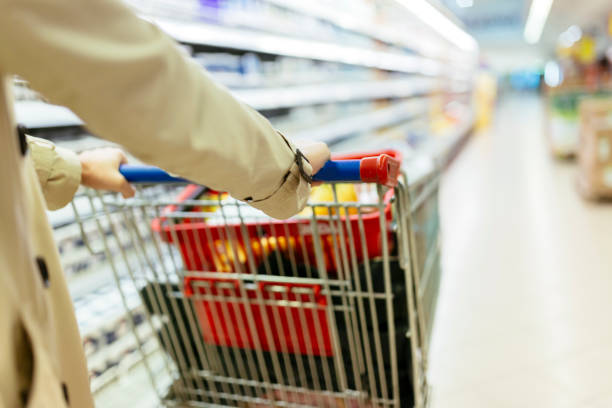 istock Woman pushing shopping trolley 875746760