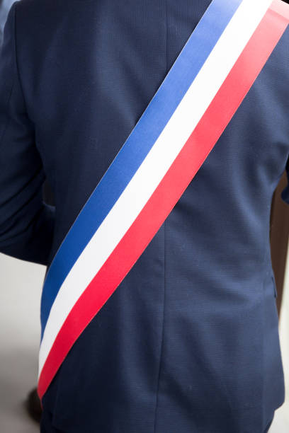 Mayor of French town with French tricolour flag mayoral sash Mayor of French town with French tricolour flag mayoral sash jib stock pictures, royalty-free photos & images