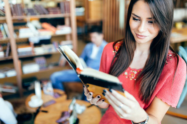istock Beautiful woman reading book 875748840