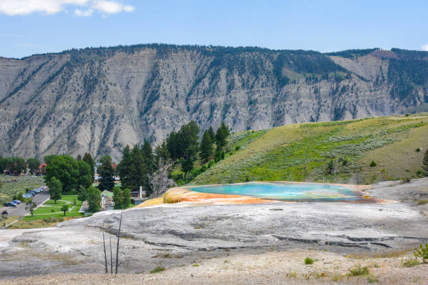 istock Mound Spring next to Liberty Cap in Mammoth Hot Springs area, Yellowstone Park. Town view. 875751042