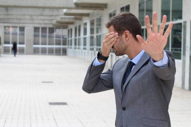 istock Business covering his eyes to avoid reality 875751700