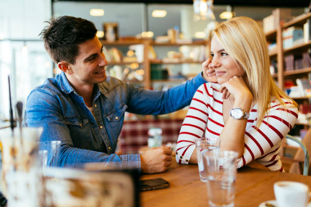 Beautiful couple in love flirting in cafe Beautiful couple in love flirting in restaurant and bonding charming stock pictures, royalty-free photos & images
