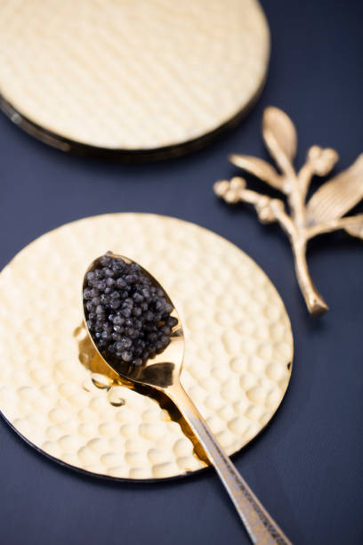 istock black caviar on a golden spoon in a beautiful black and white composition 875753100