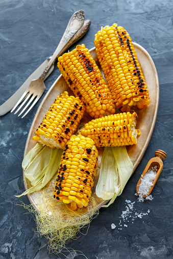 Sweet corn grilled with sea salt on a plate, selective focus.