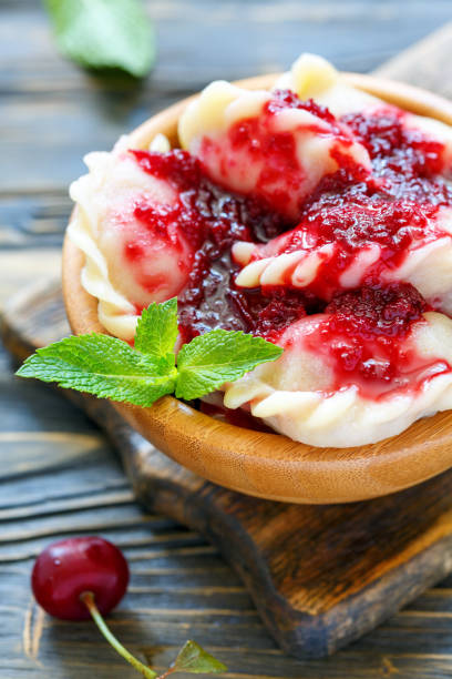 istock Dumplings with cherries and berry sauce. 875759294