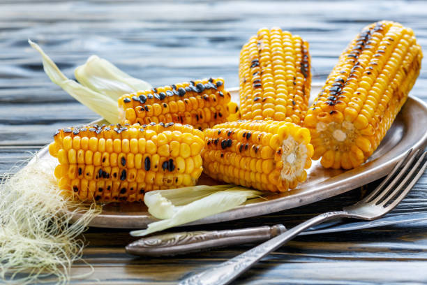 istock Cobs of sweet corn roasted on the grill. 875763514