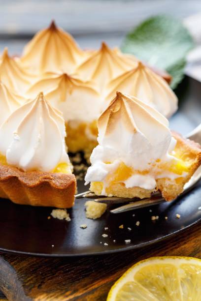 istock Piece of lemon tart on a fork closeup. 875771406