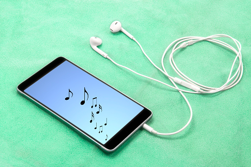 Music Notes On Smartphone Screen With Headphones