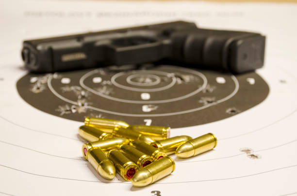 istock Pistol with bullet on the scorched target. 875777990