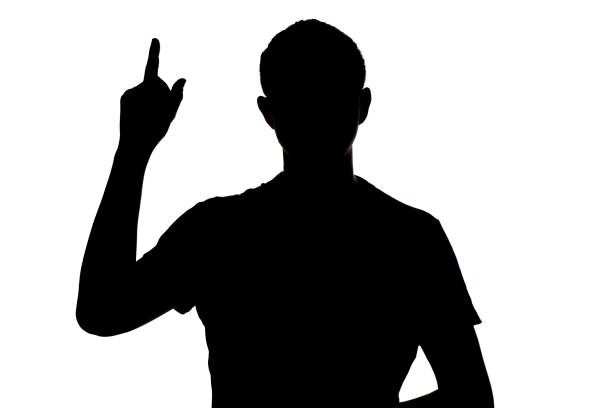 istock silhouette of an unknown man who dawned on a thought on a white isolated background, concept idea, the man raised his finger up 875781114