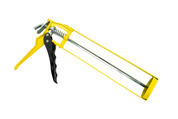 istock Yellow and black glue gun cut out on a white background. 875788260