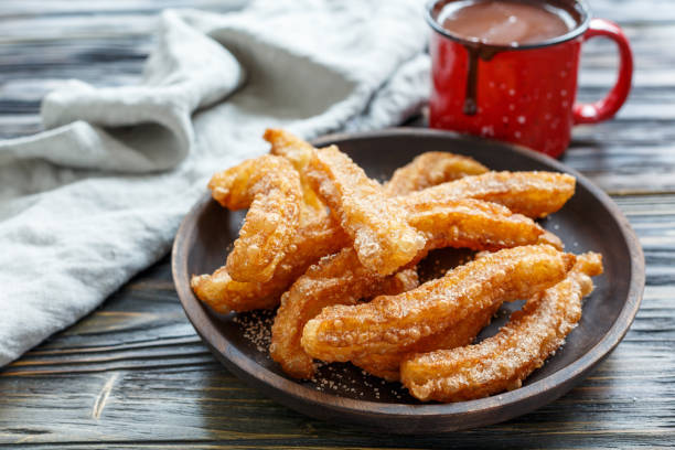 istock Dish with churros and hot chocolate. 875790070