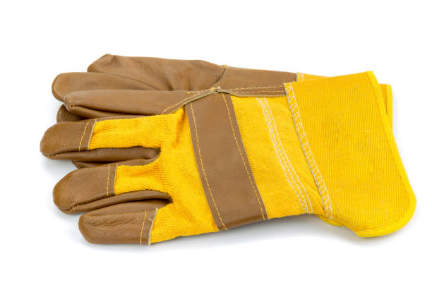 istock Yellow leather and cotton protective gloves cut out on a white background. 875794134