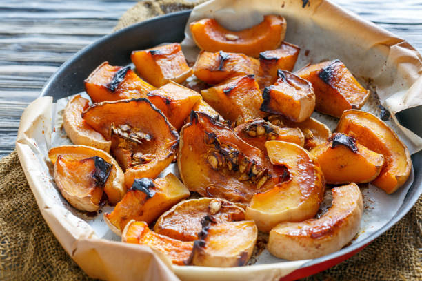 istock Pumpkin cut into pieces baked in honey. 875794416