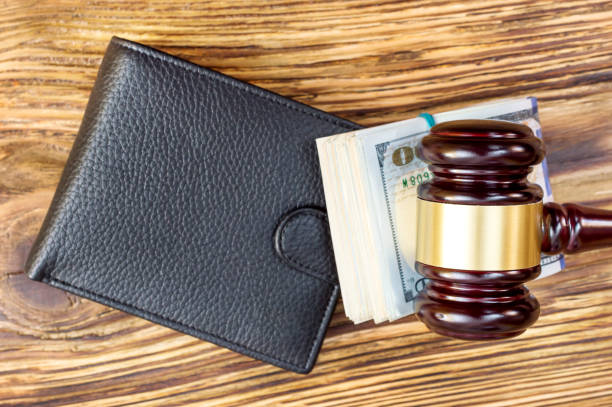 istock Judges hammer with folded dollars and wallet on the table. Top view. 875794716