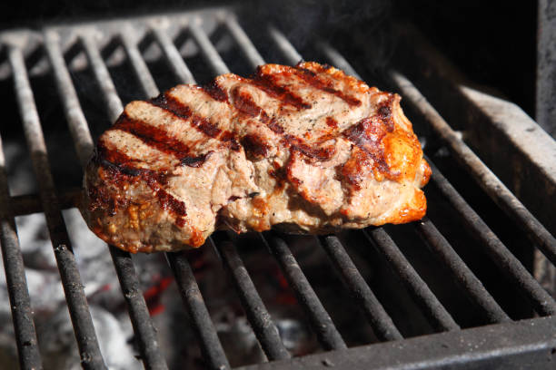 istock Preparation of steak on the grate and coals. 875808628