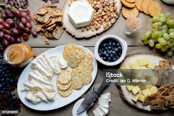 Table With Cheese And Fruit Spread Out For A Party Stock Photo - Download Image Now - Cracker - Snack, Cheese, Abundance