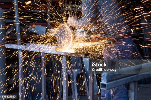 Blue Collar Worker Cutting Steel And Making Sparks Fly Stock Photo - Download Image Now