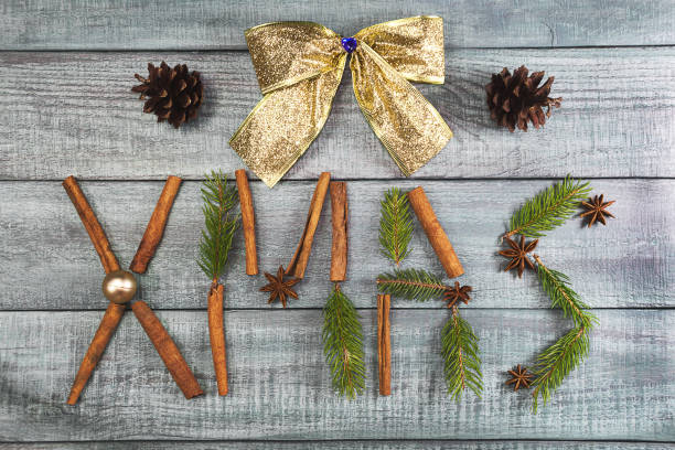 istock Christmas background or Xmas card  with decorations fir branches, pine cones, ornament, cinnamon on the wooden green backtop. Winter holiday postcard. Vintage style. Top view and flat 875826236