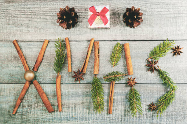 istock Christmas background or Xmas card  with decorations fir branches, pine cones, ornament, cinnamon, present on the wooden green backtop. Winter holiday postcard. Vintage style. Top view and flat 875826242