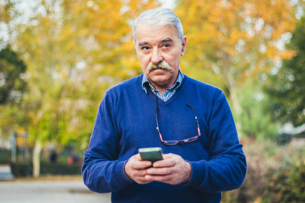 istock Senior man enjoying his smartphone outdoor. 875834638