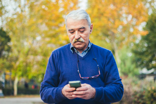 istock Senior man enjoying his smartphone outdoor. 875834764