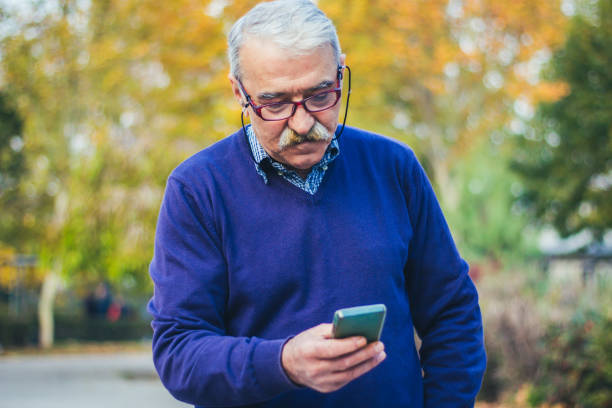 istock Senior man enjoying his smartphone outdoor. 875835242